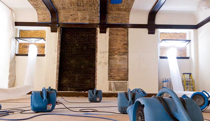 Blue air movers used in water damage restoration