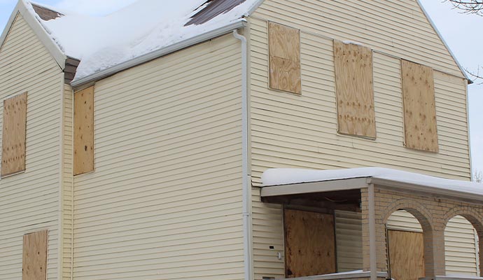 Windows board up in winter.